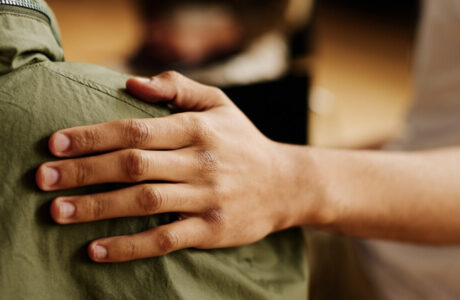 Person providing a supporting arm to a grieving person