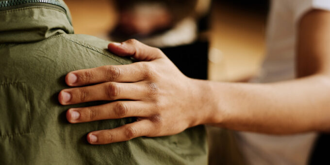 Person providing a supporting arm to a grieving person