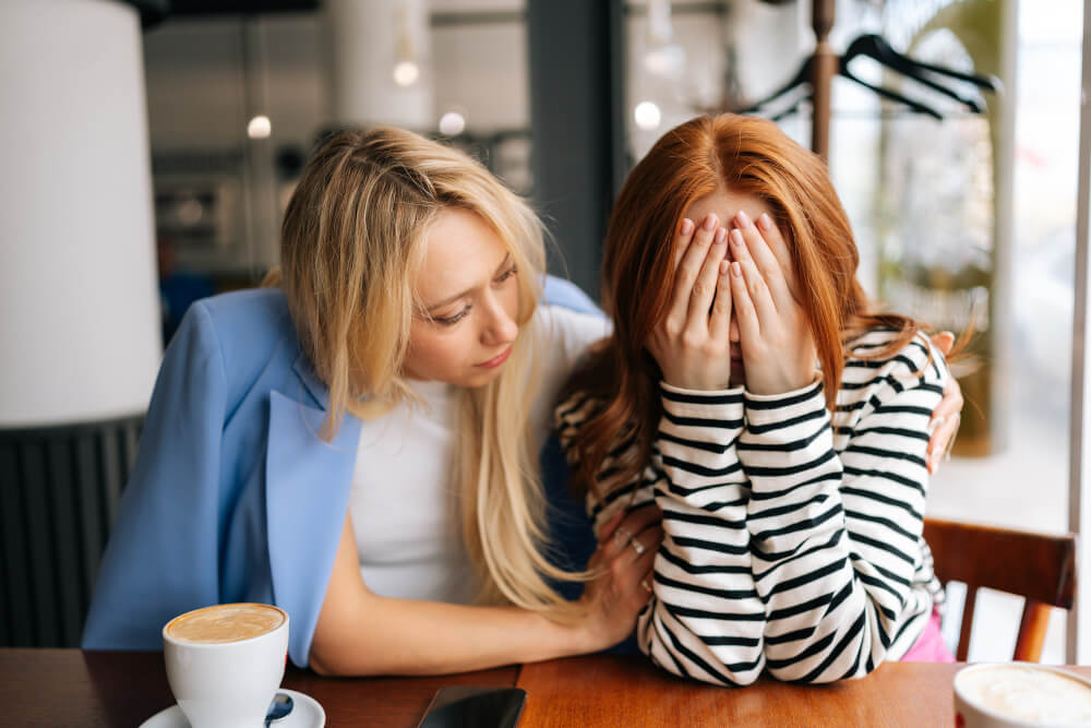 A woman comforting a crying woman